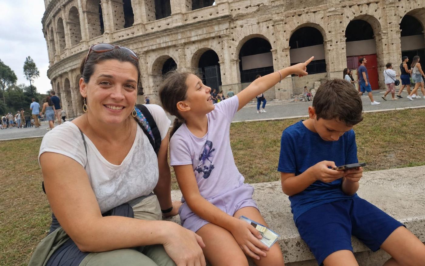 A family with a phone on the free mission by the Colosseum