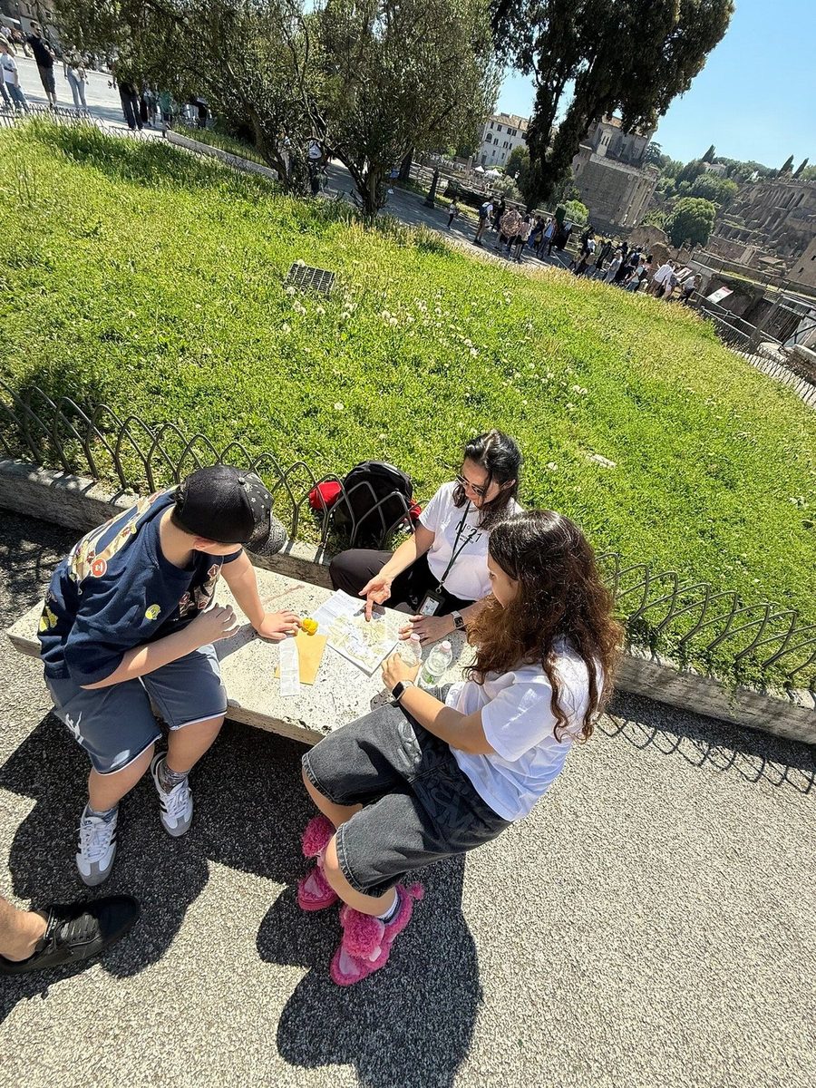 Children work through quest tasks sitting on a parapet