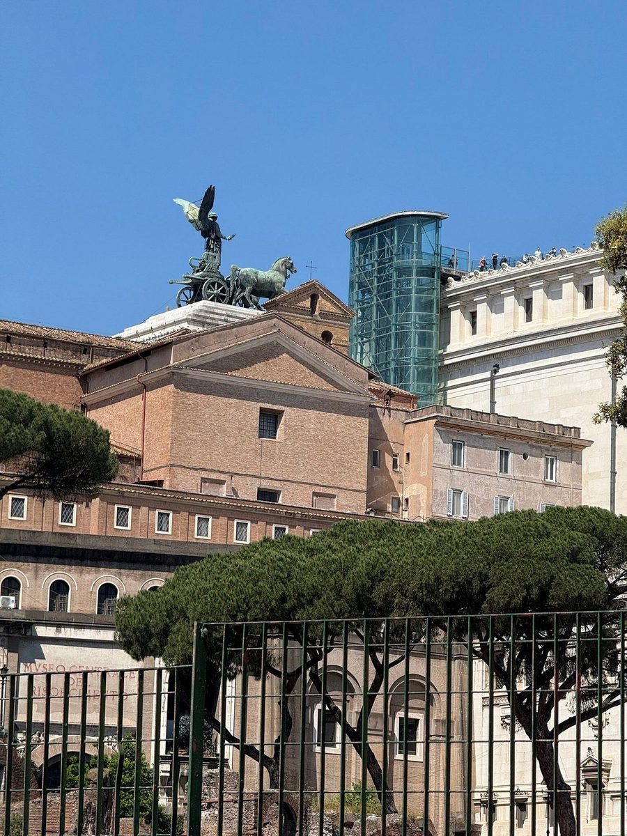 The Vittoriano and the roofs of Rome through a wrought-iron railing
