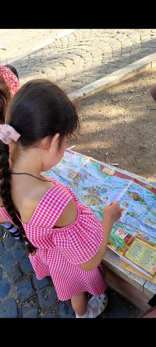 A girl studies the quest map by the walls of the Colosseum