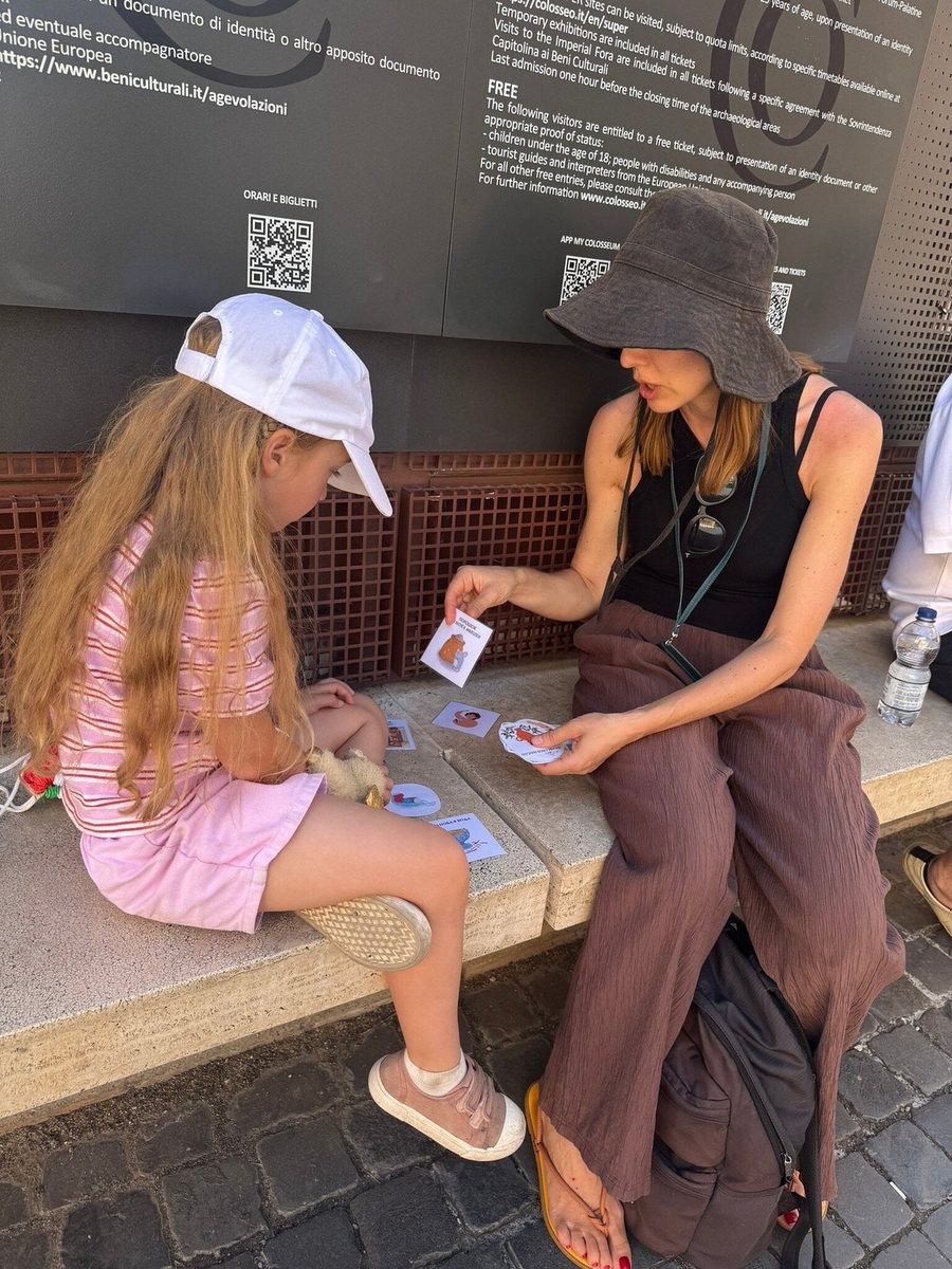 Mother and daughter go through the quest cards on a parapet