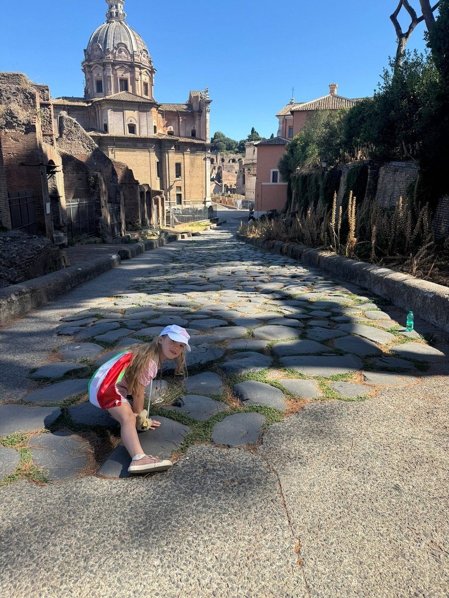A boy on the ancient pavement of the Roman Forum