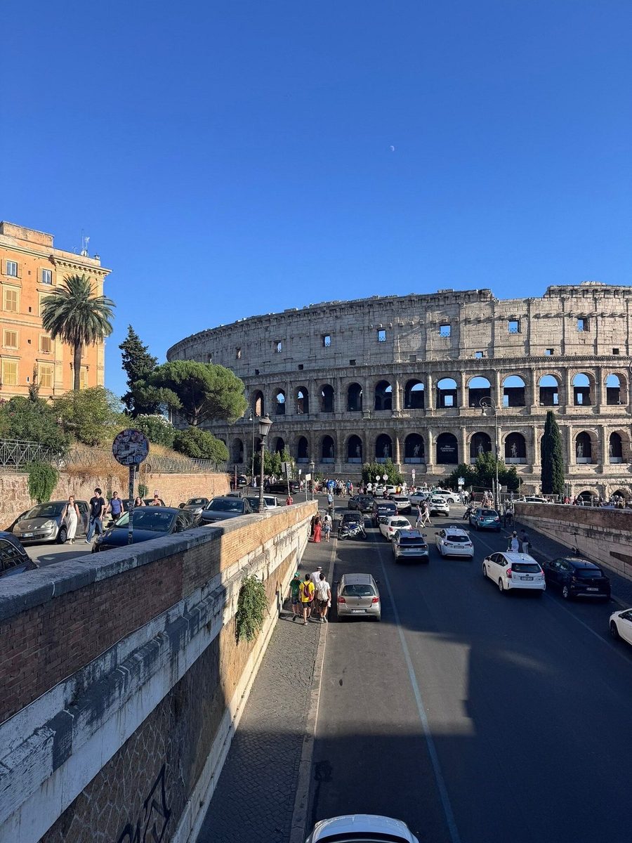 The Colosseum and the traffic seen from a bridge