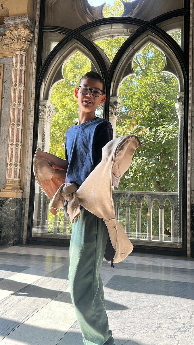 A teenager at a pointed-arch window overlooking the canal