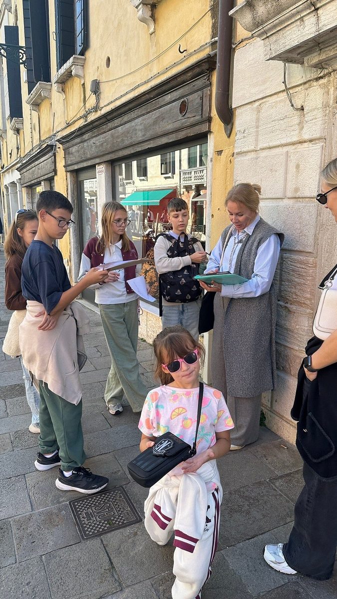 A group of children with quest materials in a city street