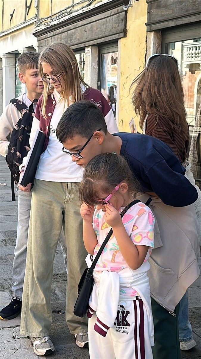 Children and adults work through a quest task together