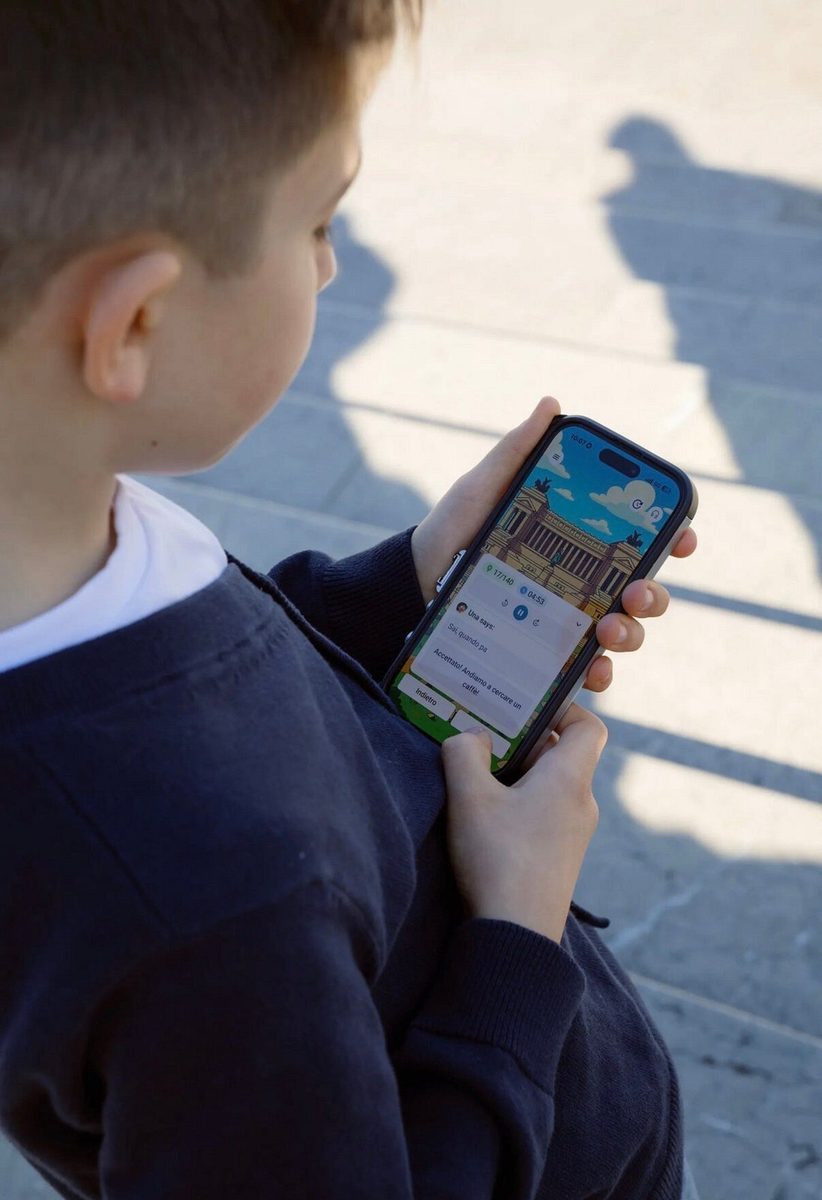 A boy holds a smartphone with the LooksArt quest open