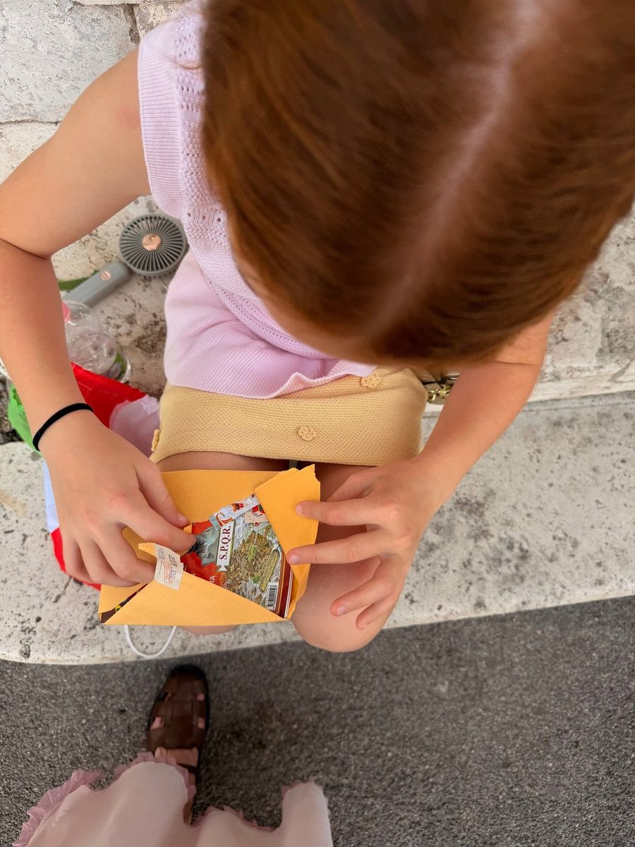 A child opens the envelope with a quest task