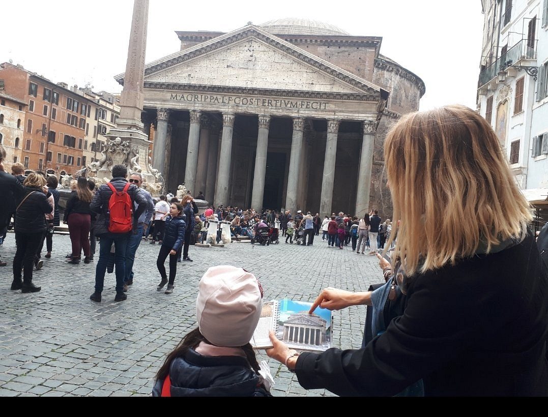 Mother and child work through a quest task by the Pantheon