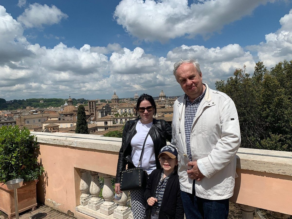 A couple with a child on a terrace overlooking Rome