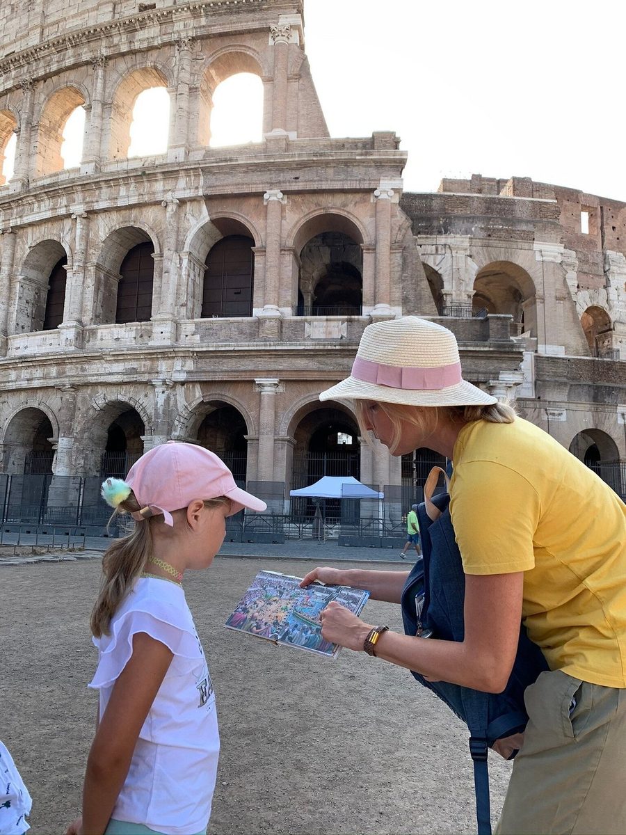 A man and a girl with the quest map by the Colosseum