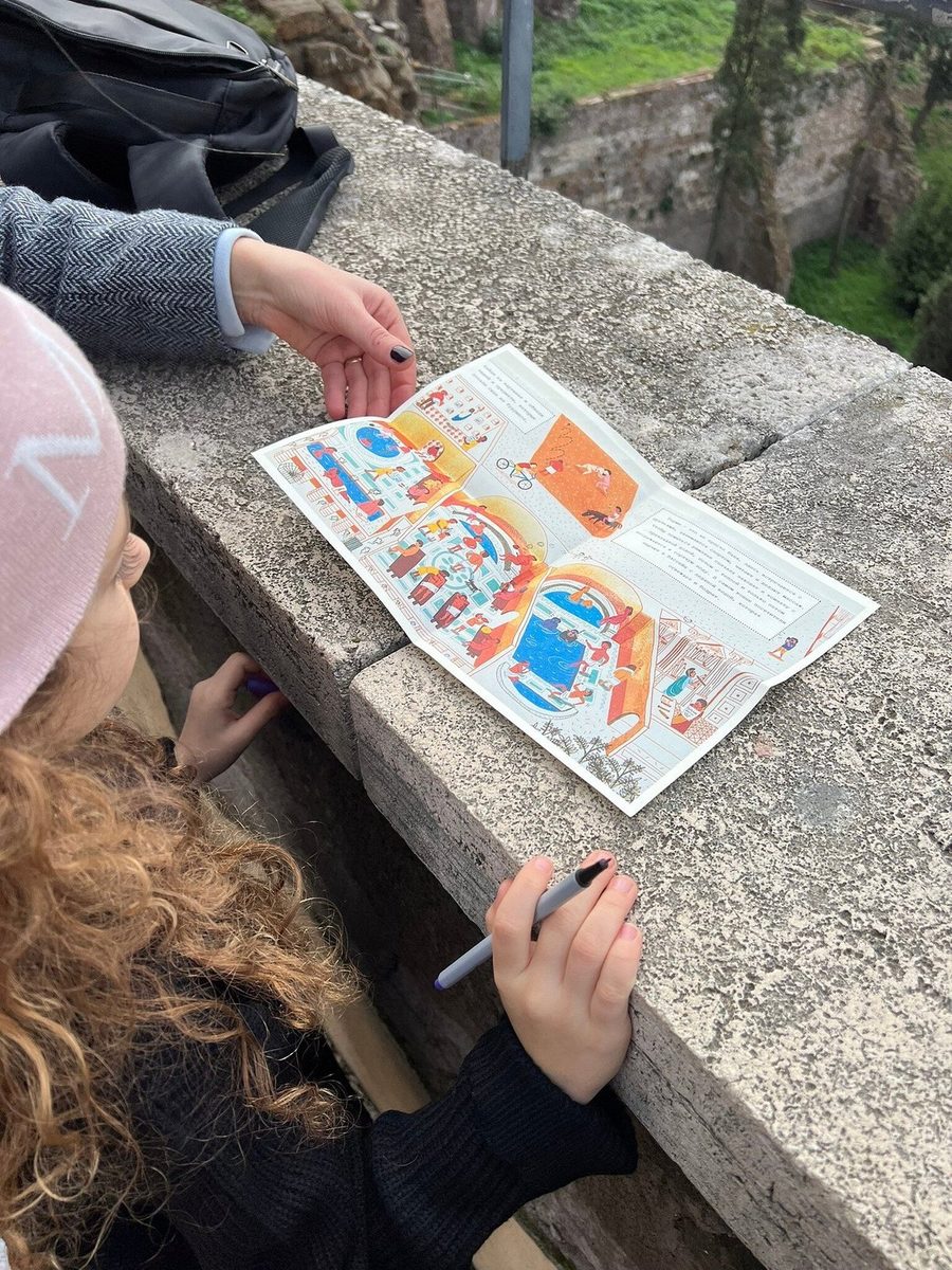 A child marks a point on the quest map lying on a parapet