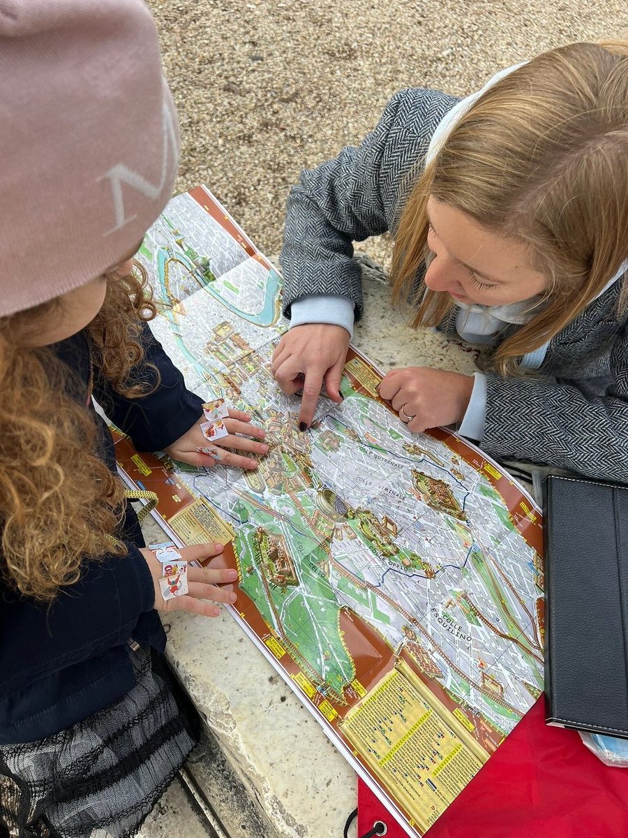 Two girls study the quest map together