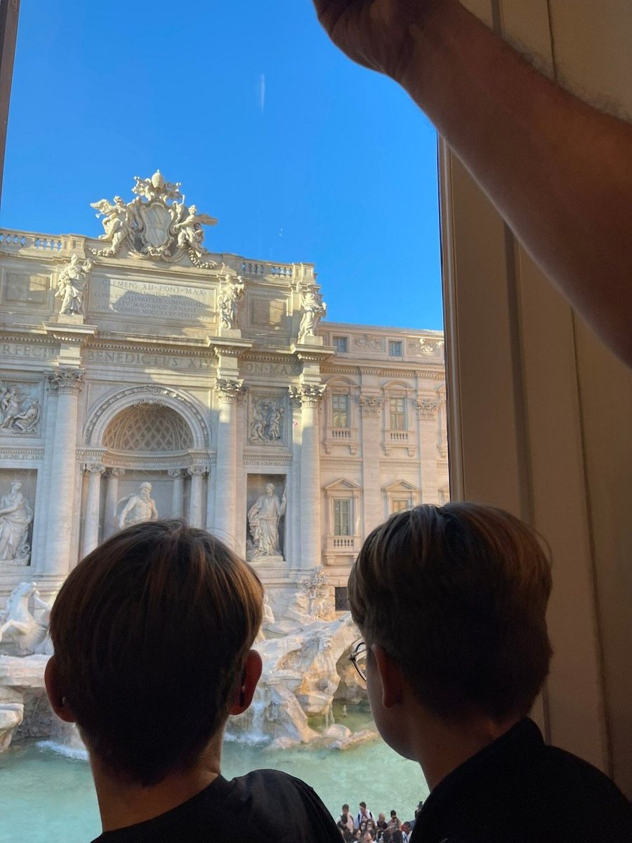 Children look at the Trevi Fountain