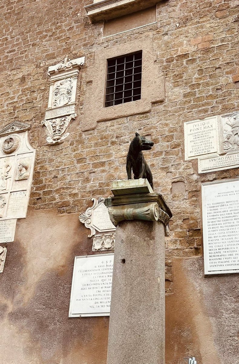 A wall with memorial plaques and old masonry