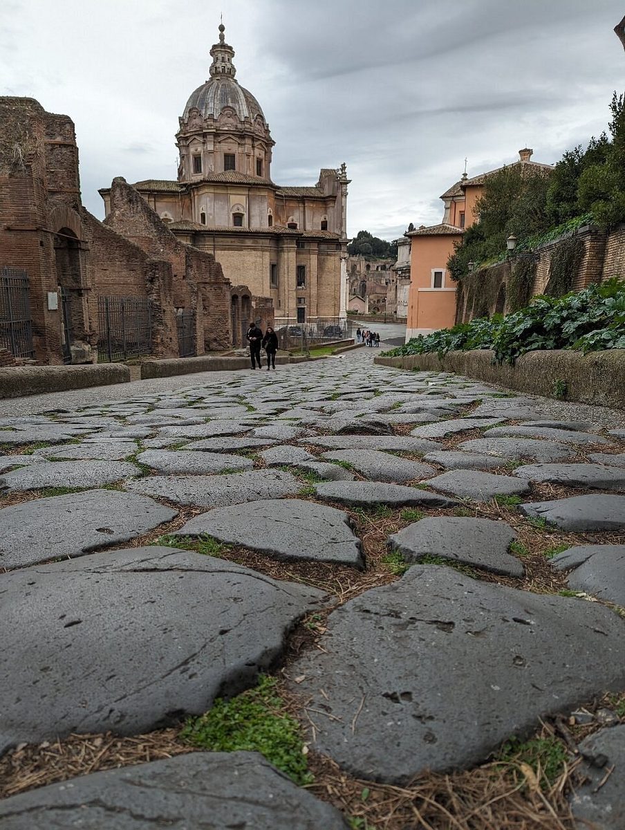 The ancient pavement of the Forum and a church dome