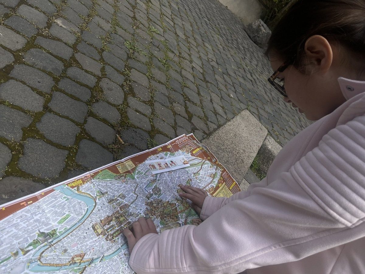 A girl studies the quest map