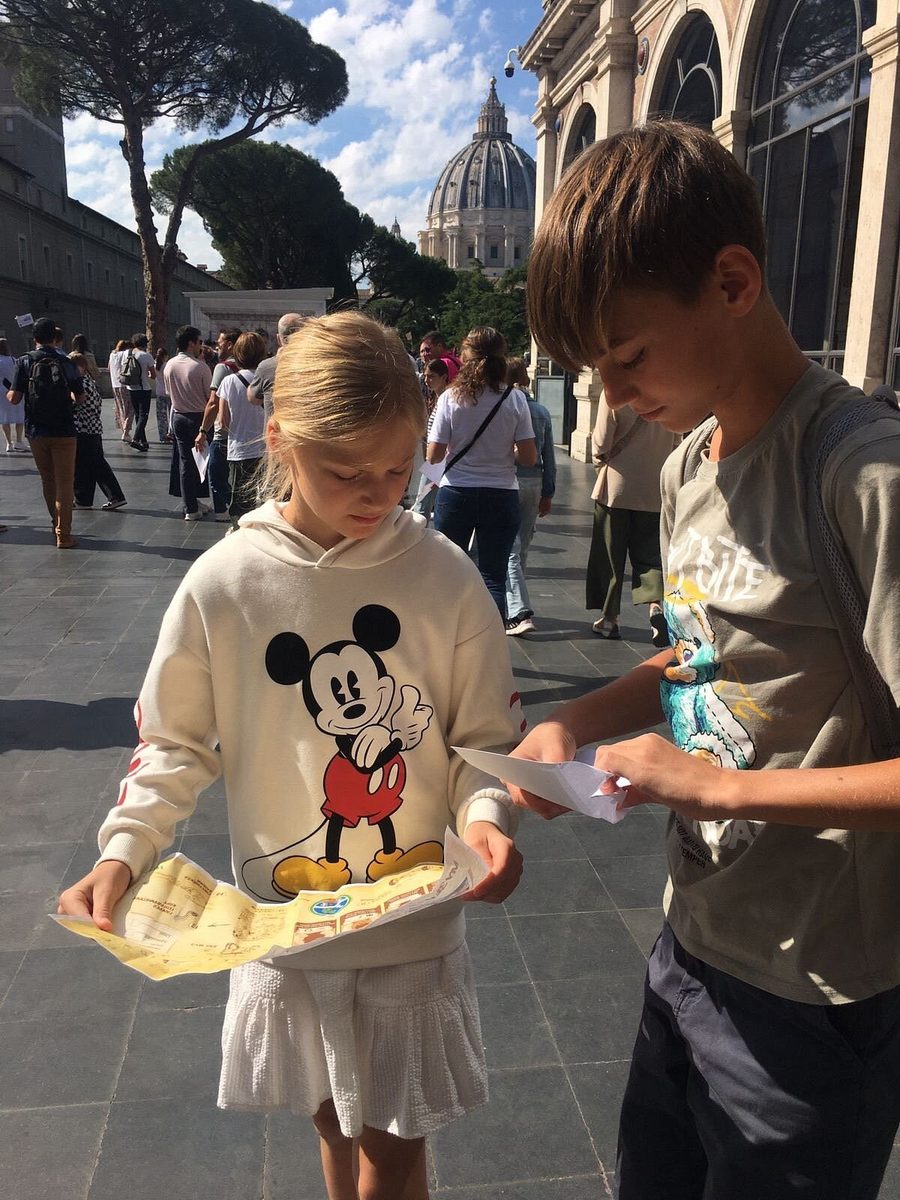 A child with the quest map in the courtyard of the Vatican Museums