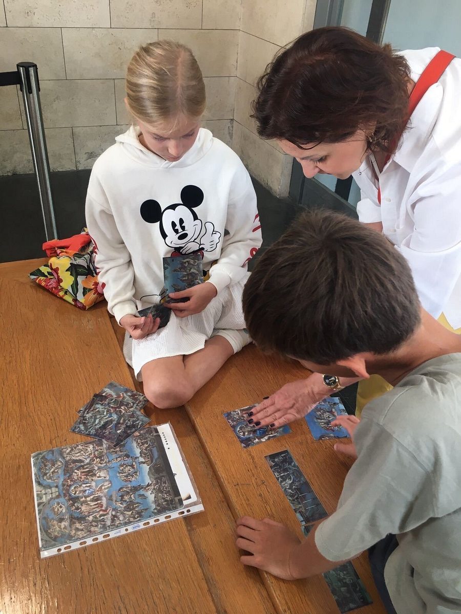 Children put together a mosaic puzzle at a table