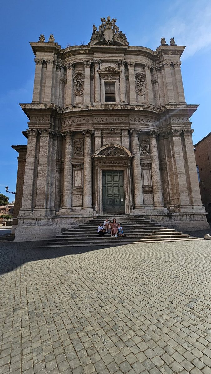 A baroque church facade on a square in Rome
