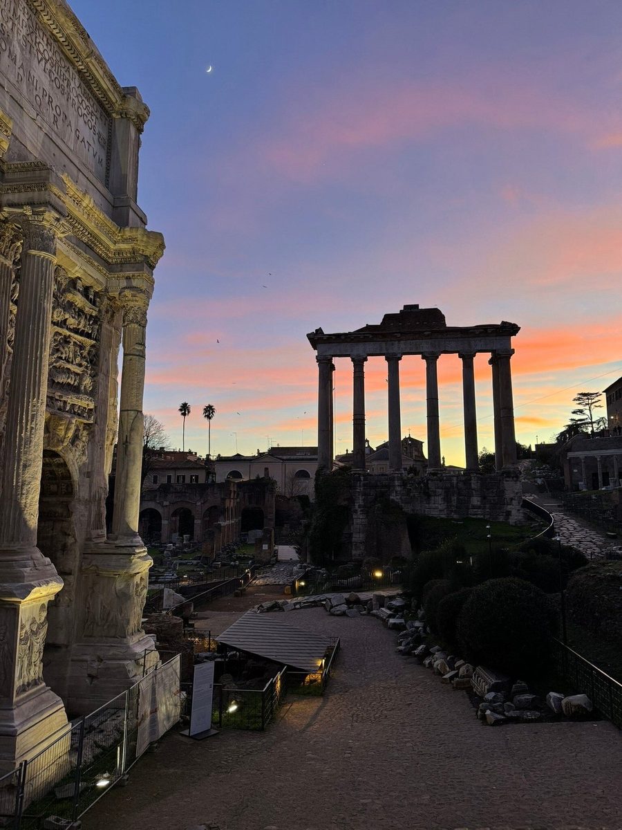 The columns of the Temple of Saturn against the sunset sky